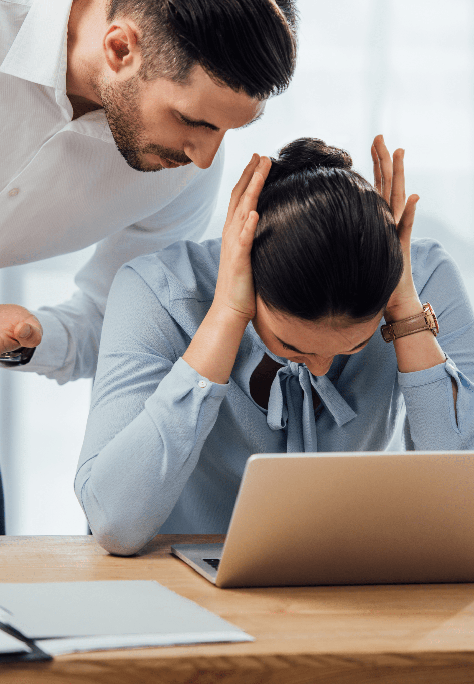 woman experiencing harassment in the workplace.