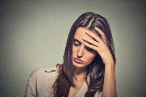 A woman who is stressed out because of covid-19 lay-offs and dismissals
