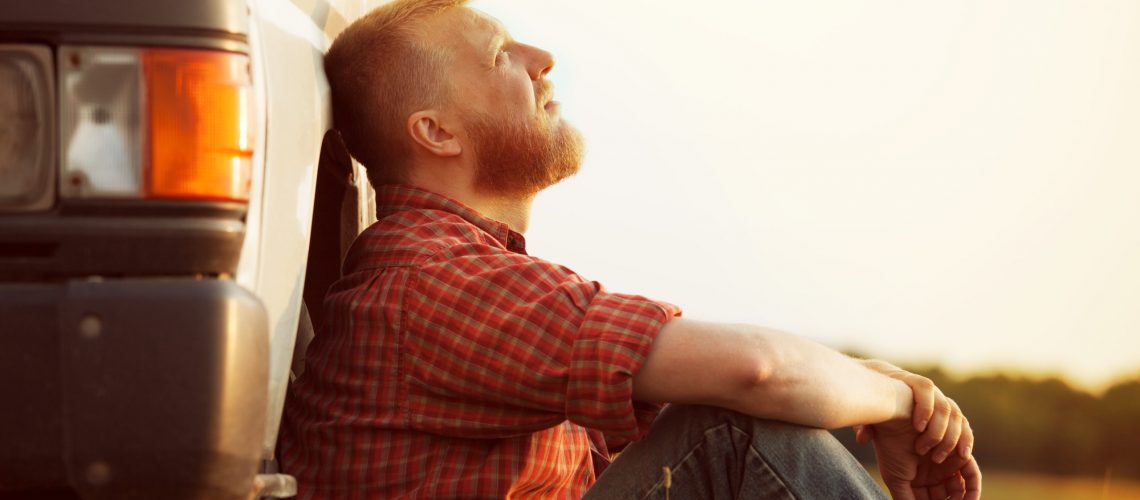 Bearded truck driver takes a break from work