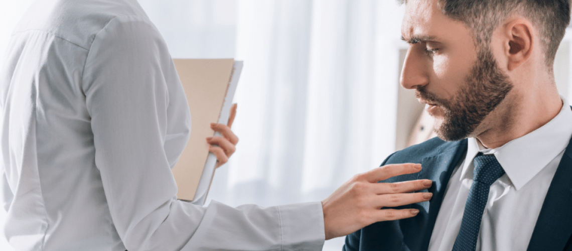 Man receiving unwanted sexual advances in the workplace.