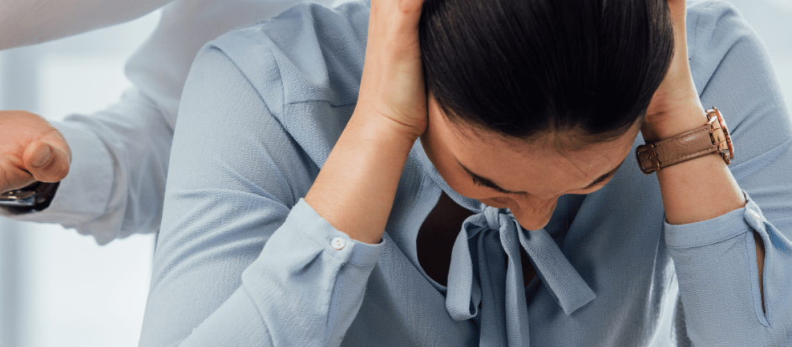 woman experiencing harassment in the workplace.