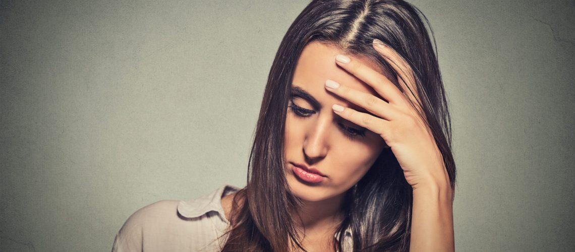 A woman who is stressed out because of covid-19 lay-offs and dismissals