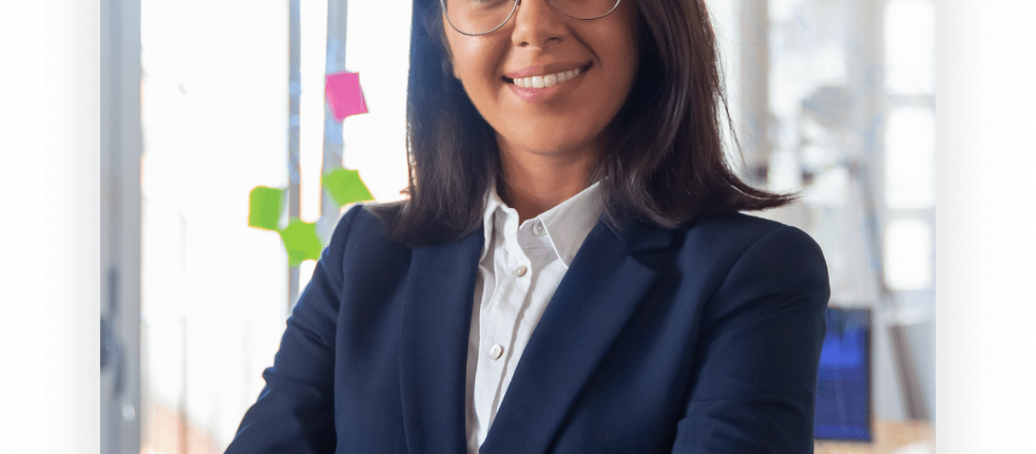 confident-latin-business-leader-portrait-young-businesswoman-in-suit-and-glasses-posing-with-arms-folded-looking-at-camera-and-smiling-female-leadersh@2x